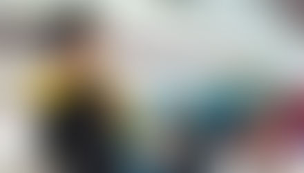 cabin attendant showing life jacket to passengers in pre-takeoff safety demonstration