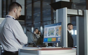 passenger passing through scanner at airport security check