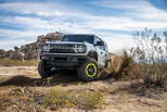 2027 Ford Bronco RTR unveiled in Detroit shown in front three-quarter view with RTR grille, Hyper Lime accents, rugged tires and raised suspension