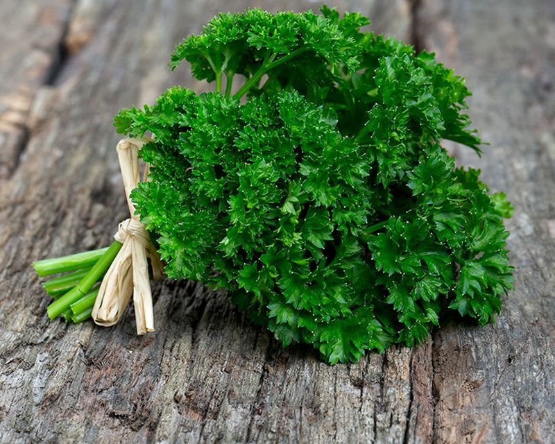 parsley on wood plank