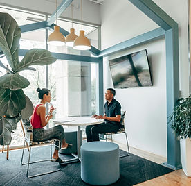 One-on-one professional coaching meeting in a modern workspace