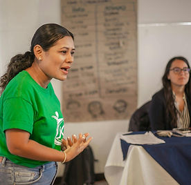 Woman speaking confidently in a professional development session