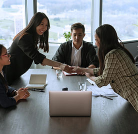 Team members shaking hands during a career workshop