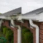 Before and after gutter whitening comparison on brick home Elkton