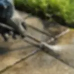 Close-up soft-wash nozzle cleaning mildew from patio paver joints Elkton