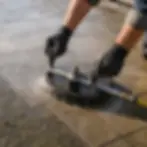 Close-up of surface cleaner tool washing paver patio stones in Elkton