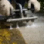 Close-up of surface cleaner removing mildew stains from driveway concrete Elkton