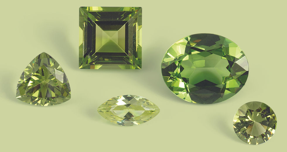 A selection of elegant peridot loose stones showcasing a variety of cuts and shades of green.