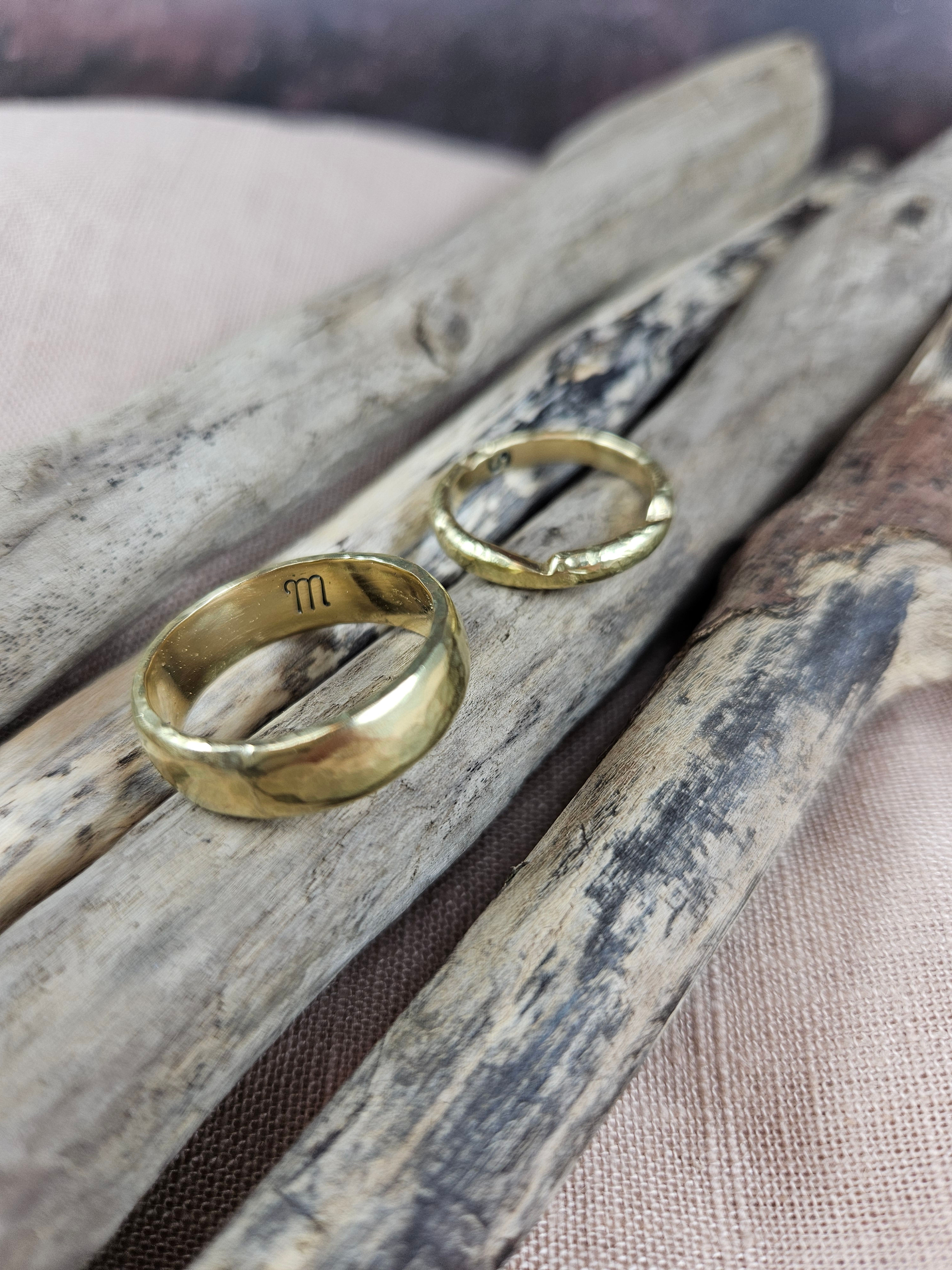 Finished yellow gold wedding rings with internal initials, made during the wedding ring workshop.