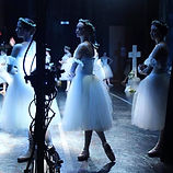 Dancers on stage in white tutus