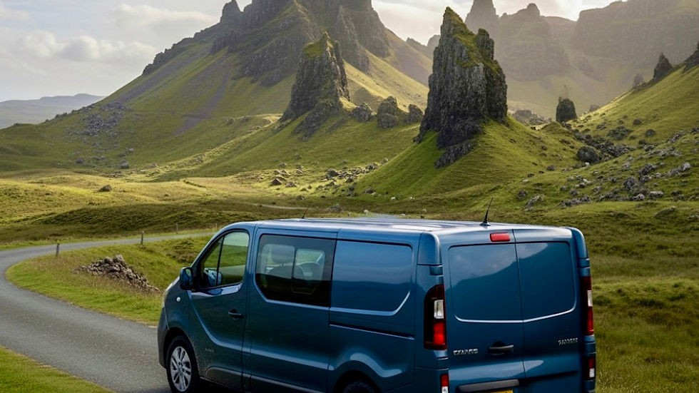 Blue van on winding road in lush green hills, with sharp, jagged peaks under a partly cloudy sky. Mood is serene and adventurous.