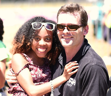 David Billingham SFAH Camp Director at special needs camp holding smiling camper