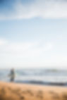 surfer-standing-by-ocean.jpg