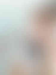 woman in mickey hat smiling on cruise ship deck with castaway cay in the background