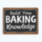 Brown-framed chalkboard sign reads "Build Your Baking Knowledge" in white letters against a black background.