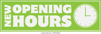 Green sign with bold white text reads "NEW OPENING HOURS" beside a clock graphic, conveying a change in business hours.