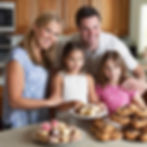 Smiling family in a kitchen with wooden cabinets, holding plates of assorted pastries and cookies. Warm, joyful atmosphere.
