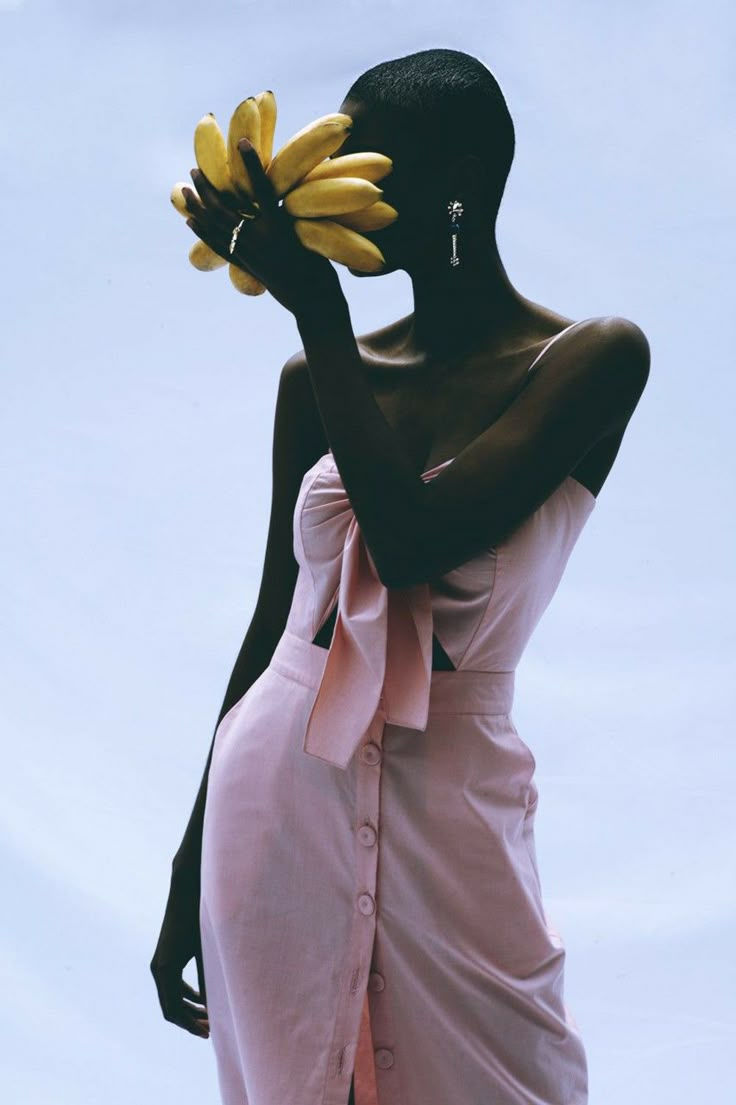 a black woman in a pink dress