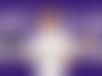 A young boy holding a tablet and a book