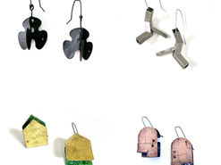 Four sets of hanging metal earrings cut into various detailed shapes.