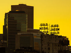 The Gold Metal Flour building and surrounding cityscape, against a yellow sky.