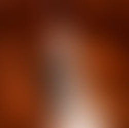 The inside of a rocky orange cave, bathed in bright light.