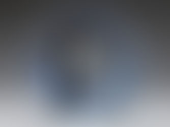 A round blue pottery dish with patterned edges and a black illustration of bamboo.