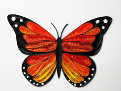 A monarch butterfly made from tiny rolls of paper.