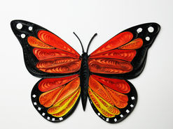 A monarch butterfly made from tiny rolls of paper.