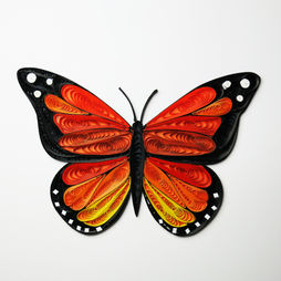 A monarch butterfly made from tiny rolls of paper.