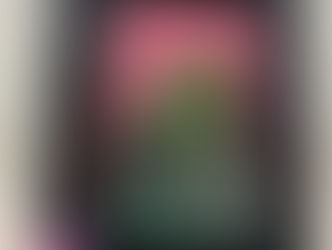 A mixed media portrait of a smiling green humanoid with an open third eye, in a black frame decorated with butterflies.