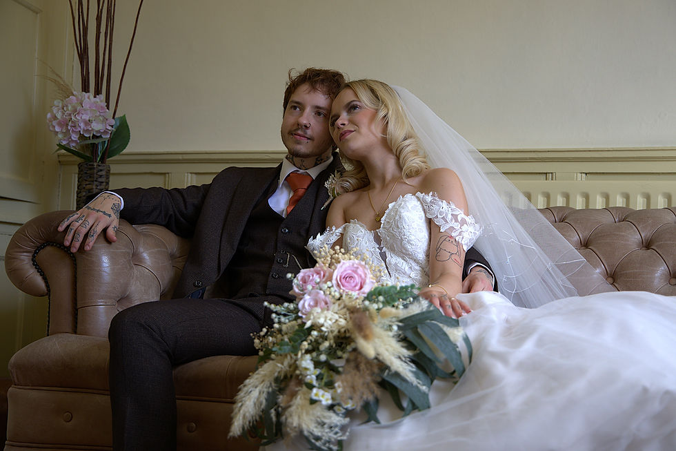 Eye-level view of a wedding videographer filming a couple exchanging vows