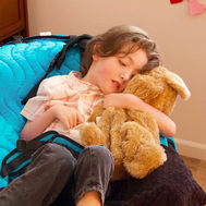 Child peacefully sleeping with a stuffed animal