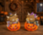 Light‑up resin Highland cow duo sitting in jack‑o’-lanterns with witch hat and bow, holding lollipops for Halloween.