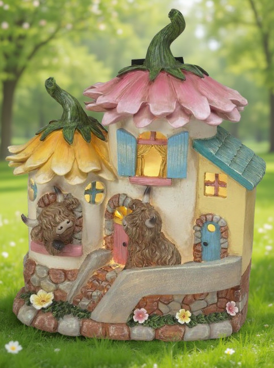 Solar-powered flower house with highland cows in a spring background.