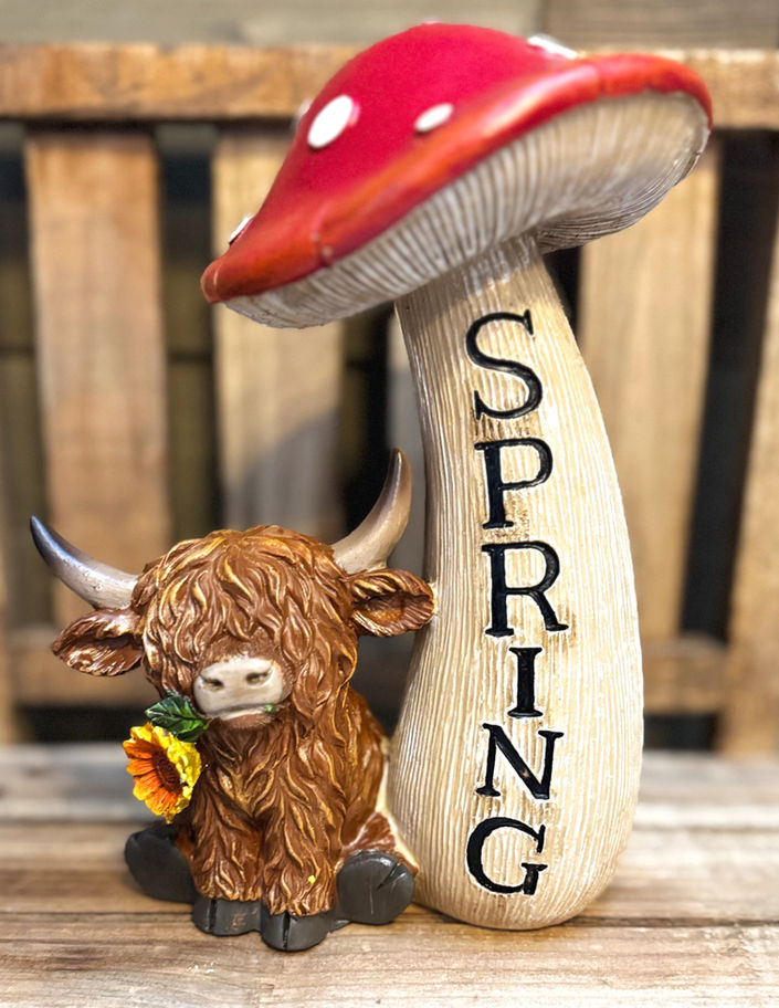 Highland cow figurine holding a red mushroom, rustic farmhouse spring decor, perfect gift for cow lovers.