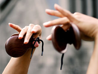 Student learning Spanish culture through castanets music workshop.
