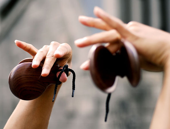Student learning Spanish culture through castanets music workshop.