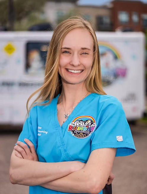 Smiling Dr. Armstrong in blue scrubs with a colorful logo.