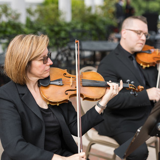 String quartet musicians performing live wedding ceremony music outdoors at Starmount Forest Country Club in Greensboro, North Carolina.