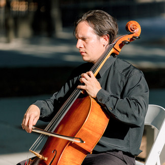 Professional cellist performing live at an outdoor corporate event in Greensboro, North Carolina, providing elegant classical music for guests and sponsors.