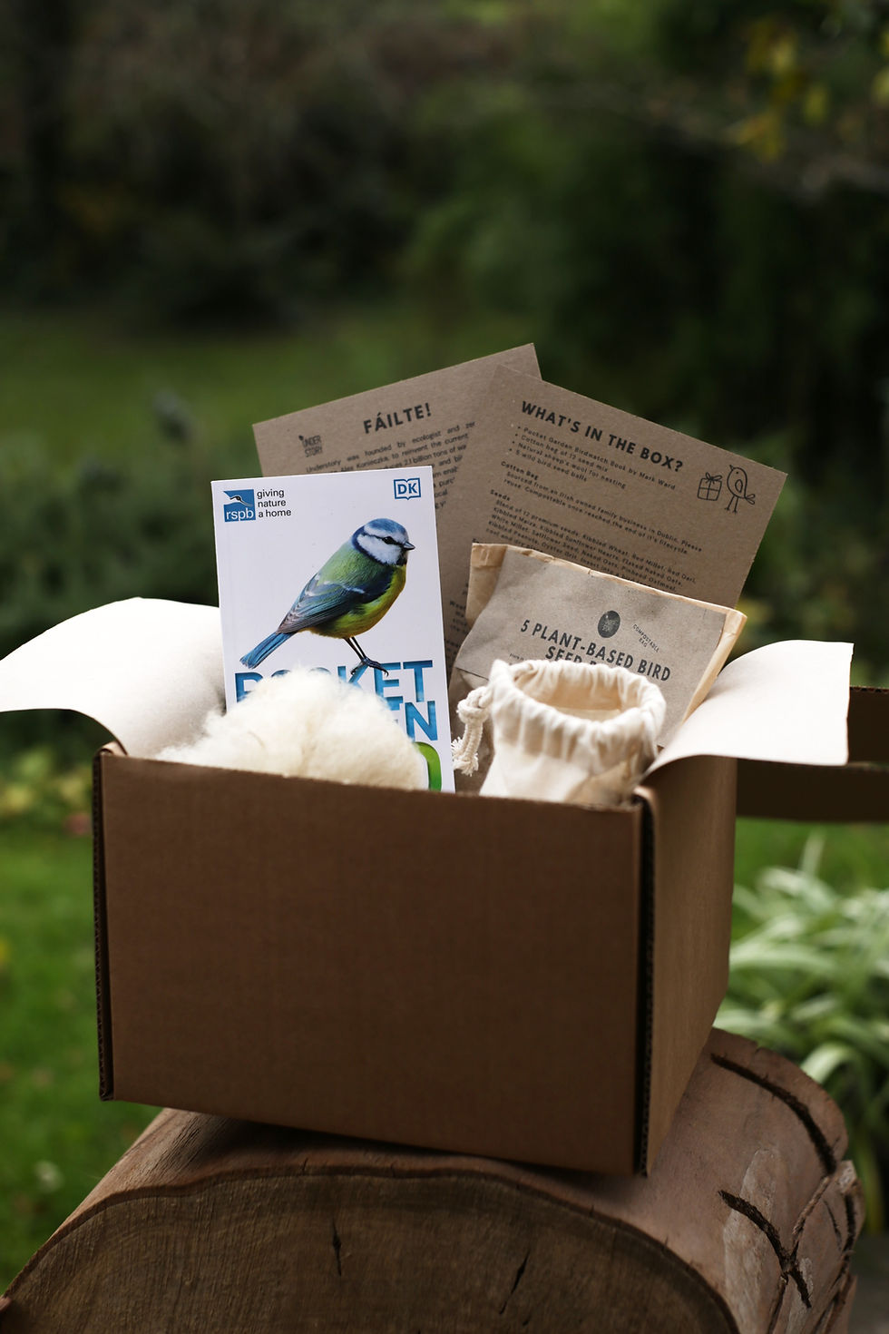 Thumbnail: Bird lover Gift Kit with products inside including a bird guide, wool, loose bird seed in a cotton bag and bird balls.
