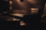 a dark dramatic close up of recording studio equipment on a desk.jpg