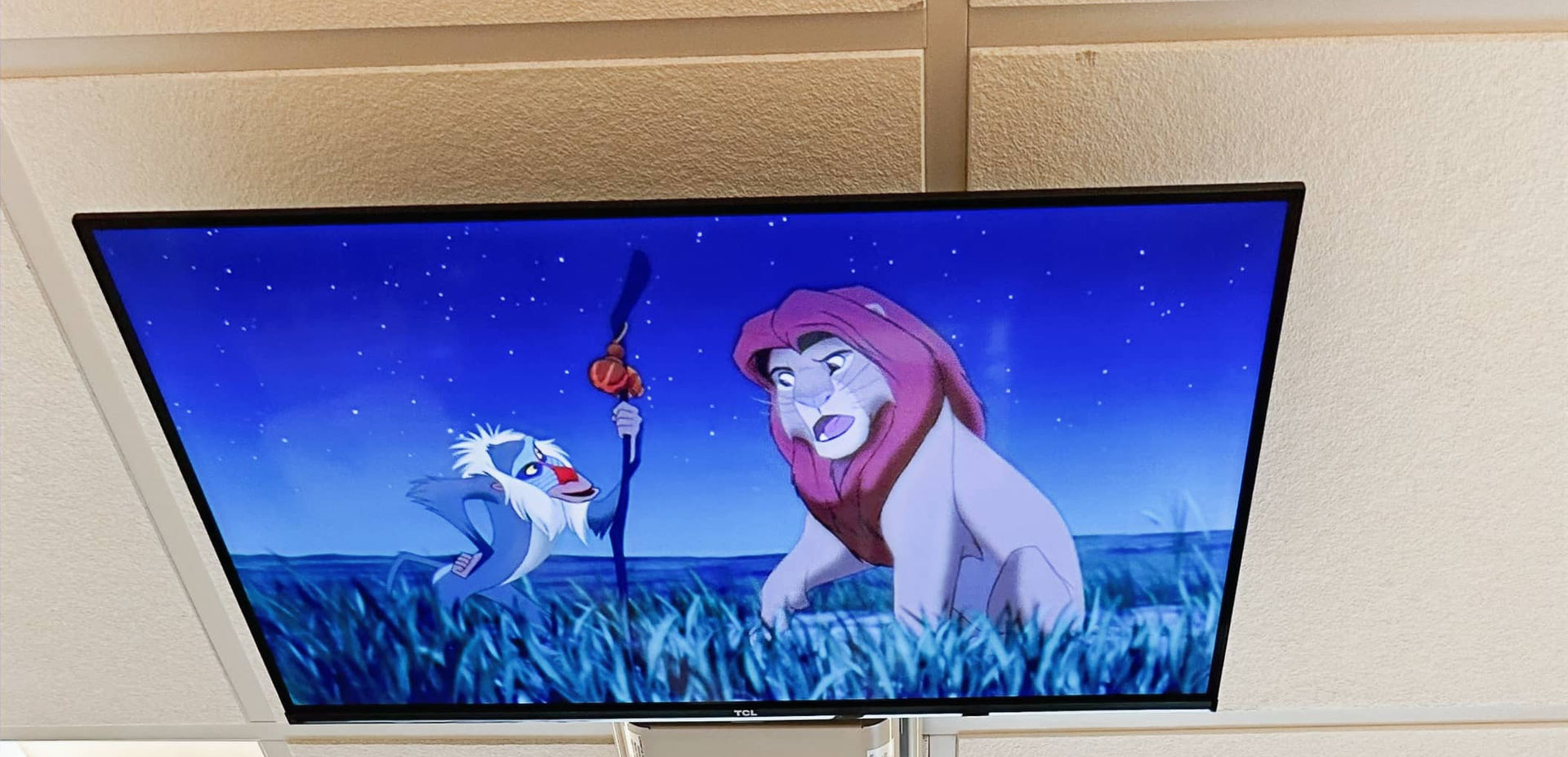 TV on ceiling with Lion King movie above dental chair