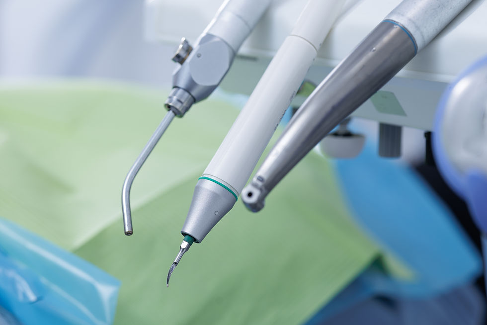 Closeup of ultrasonic scaler, suction and dental handpiece in modern dental clinic