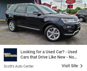 Black Ford Explorer in front of Scott's Auto Center