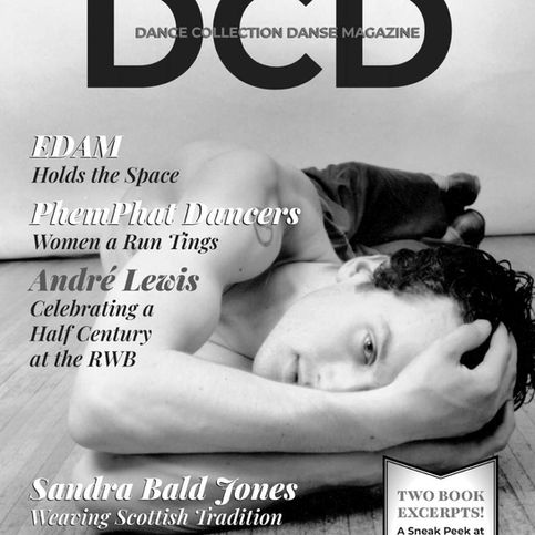 black and white photo of a man with dark hair lying on the floor, facing the camera, shirtless, his arms extended toward the camera, elbows bent, his hands and wrists obscuring half his face, one eye visible looking straight at the viewer.