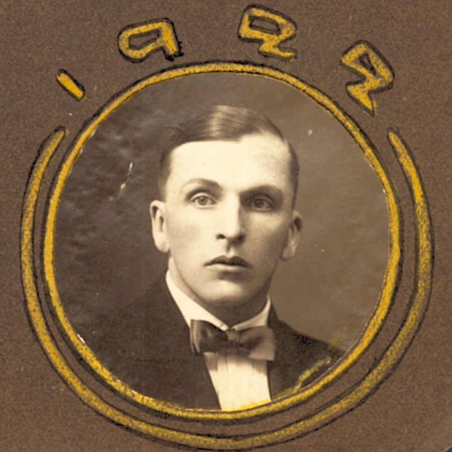 Sepia-toned portrait of Boris Björkelund (Борис Бьёркелунд). Surrounded by yellow circular design and "1929" written above..