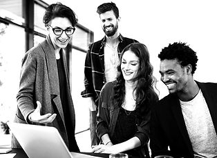 faded picture of diverse group of people looking at a laptop screen