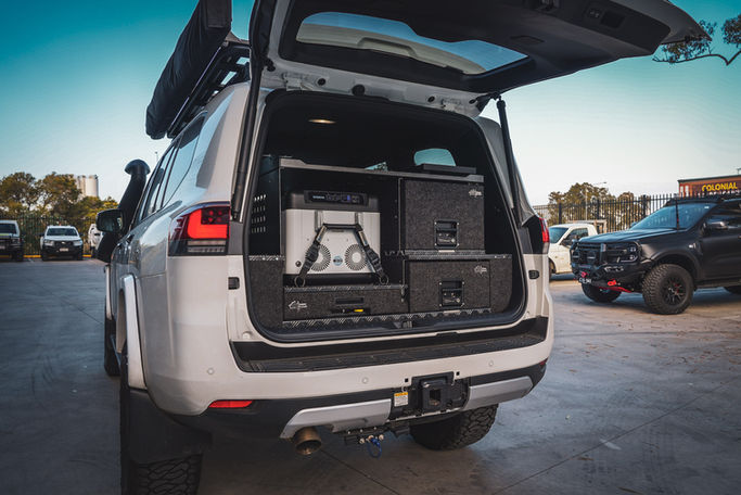 Rear view of a Toyota LandCruiser 300 Series with RV Storage Solutions twin drawer setup and fridge slide.